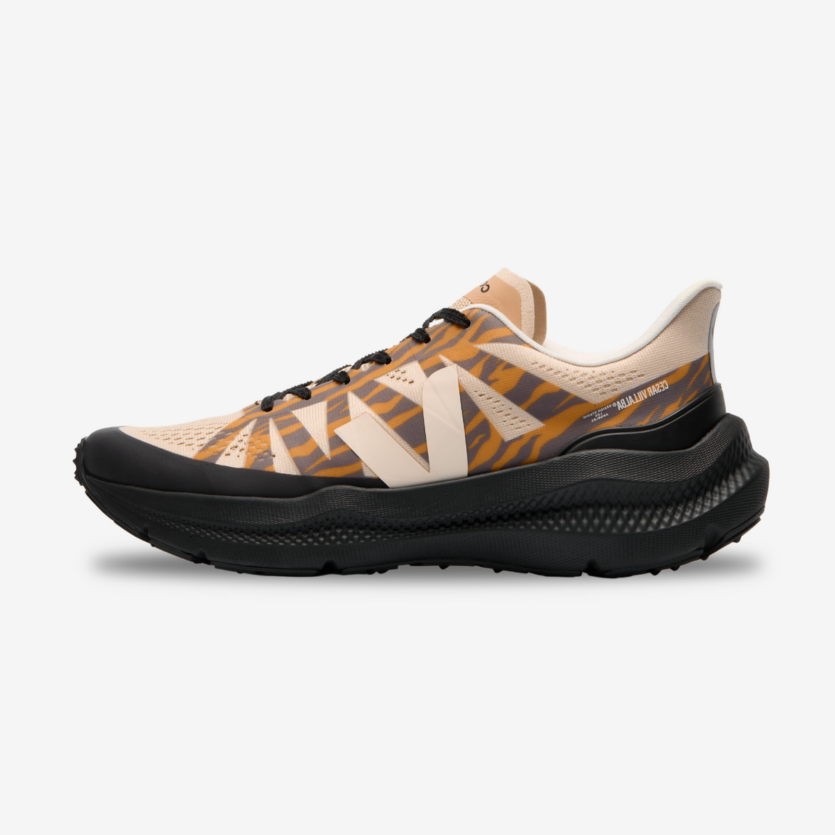 A pair of VEJA Condor 3 Advanced running shoes with a camouflage pattern in beige, black, and orange colors.